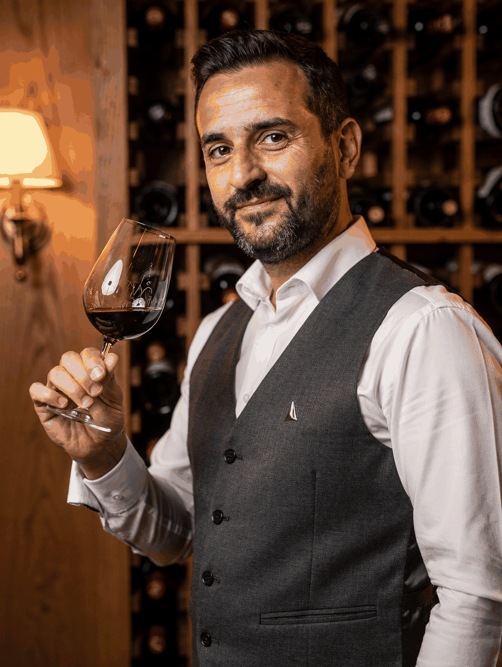 Sommelier Luca Moretti selecting a vintage wine from our cellar